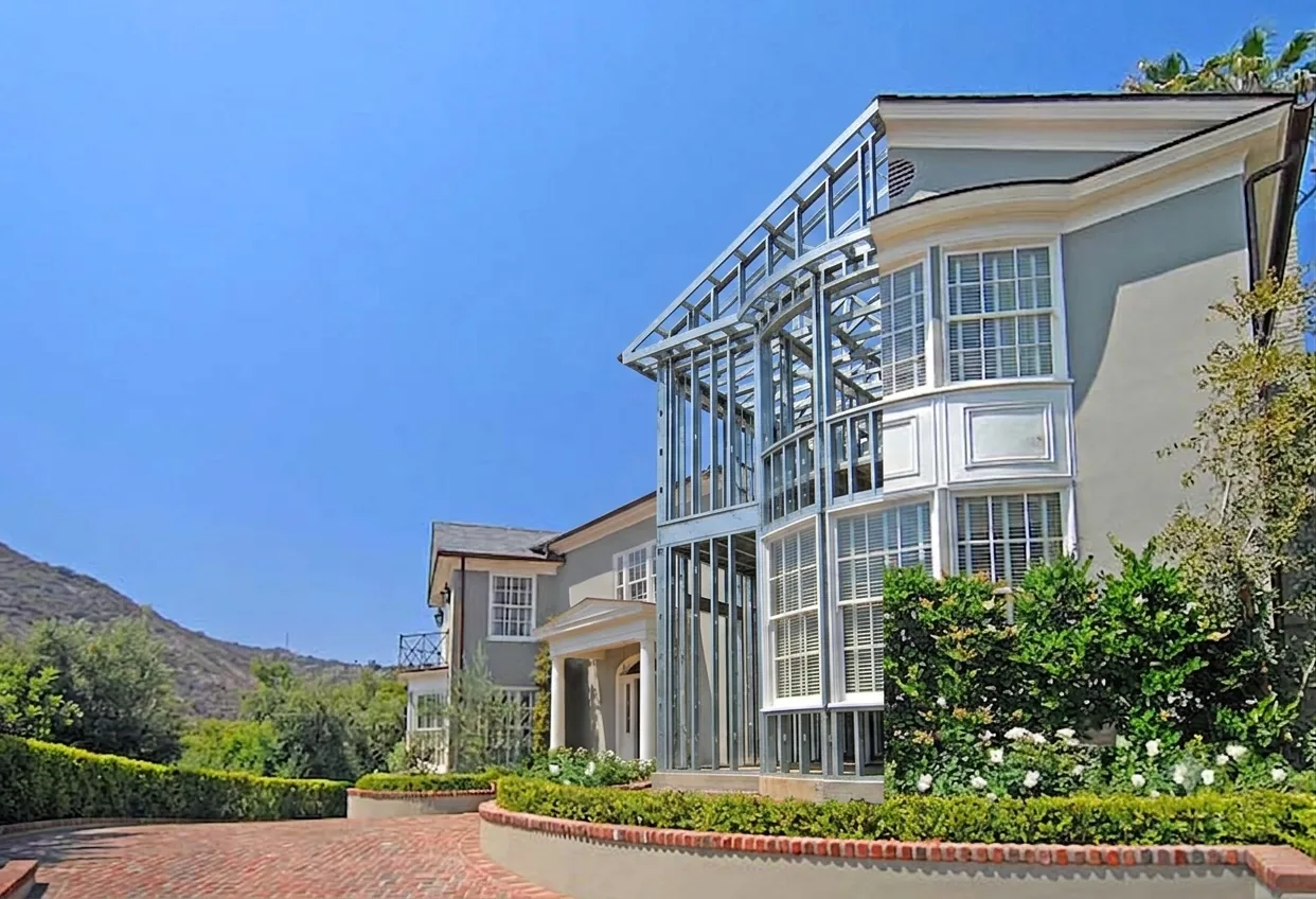Steel frame home, finished exterior beside exposed steel structural frame
